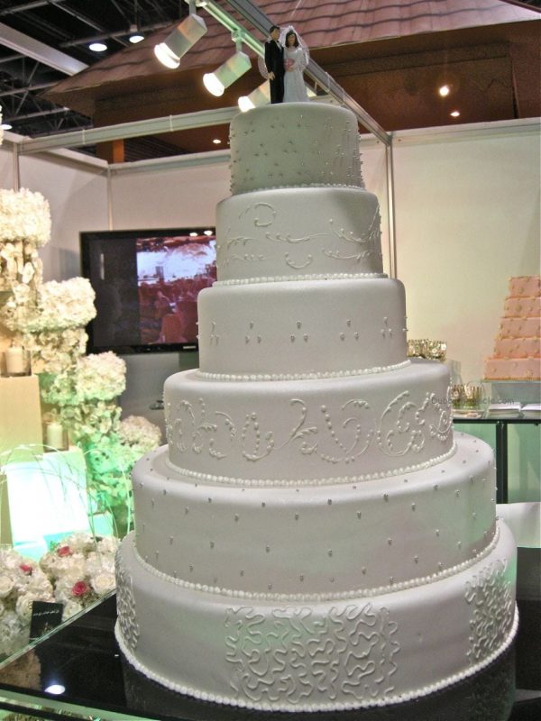 Delicate floral icedsugar ornaments decorate towering wedding cakes 