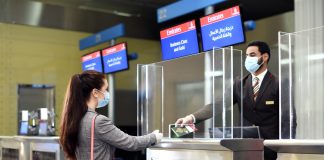 Emirates, DHA Implement Digital Verification of COVID-19 Medical Records for UAE Travellers Dubai Health Authority (DHA) interacting with a women at their kiosk