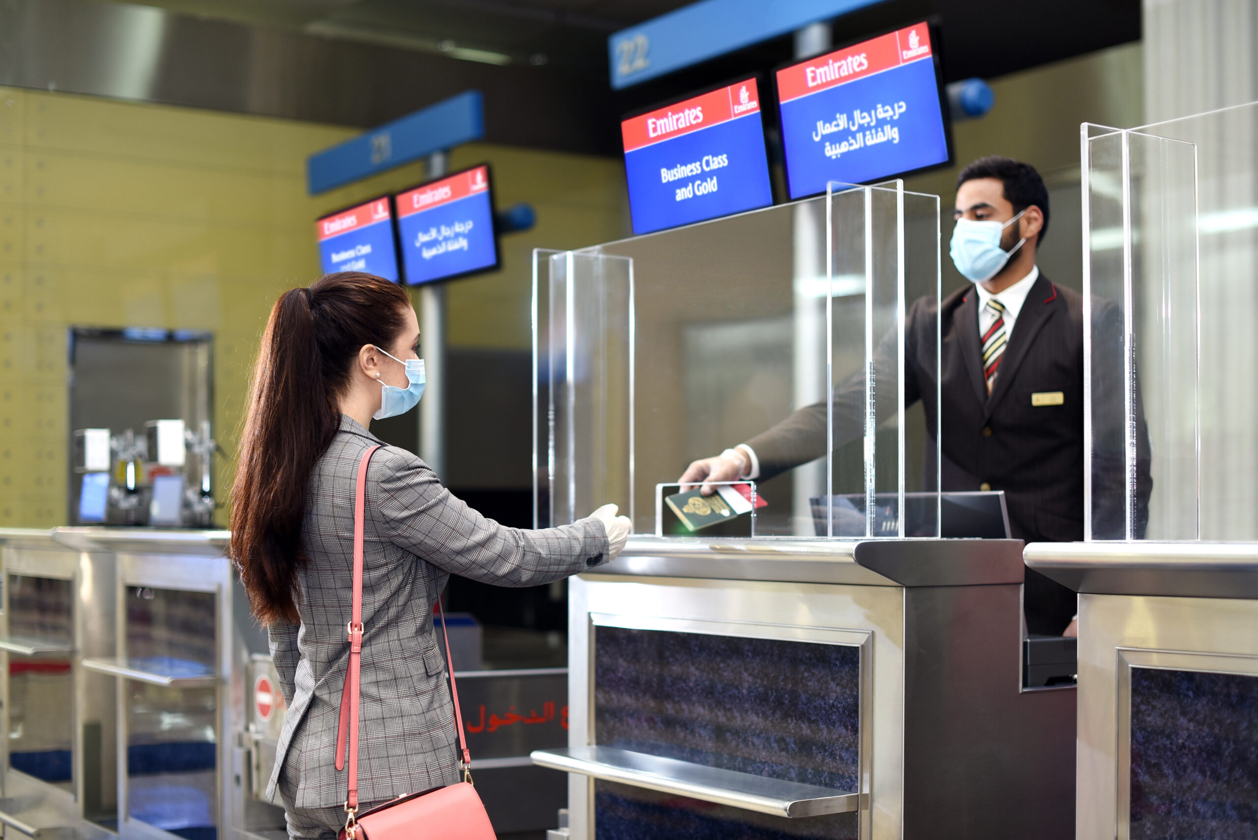 DHA Dubai Health Authority (DHA) interacting with a women at their kiosk