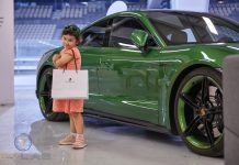UAE Welcomes First Electric Vehicle Track Day Event in Abu Dhabi’s Yas Marina F1 Circuit An electric car along with a happy child at EV Lab