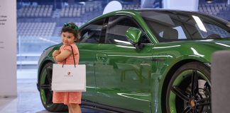 UAE Welcomes First Electric Vehicle Track Day Event in Abu Dhabi’s Yas Marina F1 Circuit An electric car along with a happy child at EV Lab