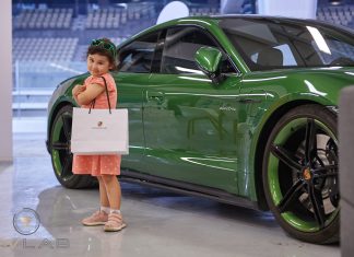 UAE Welcomes First Electric Vehicle Track Day Event in Abu Dhabi’s Yas Marina F1 Circuit An electric car along with a happy child at EV Lab