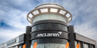 Mclaren Abu Dhabi Delivers the First 750S in UAE Representation of McLaren dealer showroom with 750S parked in front.