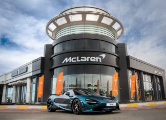 Mclaren Abu Dhabi Delivers the First 750S in UAE Representation of McLaren dealer showroom with 750S parked in front.